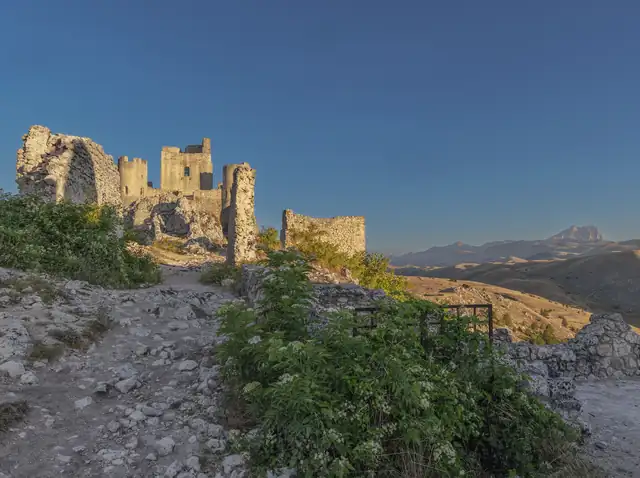 Rocca Calascio fortress above the hills, with the Gran Sasso mountains behind